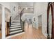 Bright, airy foyer featuring a grand staircase, hardwood floors, and soaring ceilings with views to the outside at 2045 Driftwood Cir, Fort Mill, SC 29708