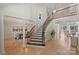 Expansive foyer showcasing a grand staircase with a dining area to one side and living space to the other at 2045 Driftwood Cir, Fort Mill, SC 29708