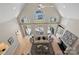 Aerial view of living room boasts vaulted ceilings, fireplace, and large windows with lake views at 2045 Driftwood Cir, Fort Mill, SC 29708