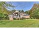 Stunning brick home with expansive lawn and lush landscaping surrounded by mature trees at 2045 Driftwood Cir, Fort Mill, SC 29708