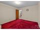 Spacious bedroom with neutral walls and plush red carpet flooring at 220 Gregory Rd, Salisbury, NC 28147