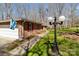 Charming brick home featuring red shutters, a well-manicured lawn, and mature trees at 220 Gregory Rd, Salisbury, NC 28147