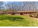 Expansive ranch-style home showcasing a brick and stone facade, a spacious lawn, and inviting red shutters at 220 Gregory Rd, Salisbury, NC 28147