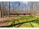 Beautiful brick ranch-style home with red shutters surrounded by a green lawn and mature trees at 220 Gregory Rd, Salisbury, NC 28147