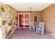 Welcoming brick front porch with stone accents, showcasing a red front door and comfortable rocking chairs at 220 Gregory Rd, Salisbury, NC 28147