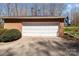 Attached brick garage with a white door, offering convenient parking and storage space at 220 Gregory Rd, Salisbury, NC 28147