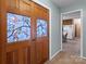 Hallway featuring decorative glass doors providing views of the bright kitchen and dining area at 220 Gregory Rd, Salisbury, NC 28147