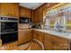 Traditional eat-in kitchen featuring wood cabinetry, built-in appliances, and a window with a scenic view at 220 Gregory Rd, Salisbury, NC 28147