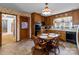 Traditional eat-in kitchen featuring wood cabinets, tile floors, and a cozy dining area at 220 Gregory Rd, Salisbury, NC 28147