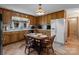Eat-in kitchen featuring wood cabinets, a classic light fixture, and tile flooring at 220 Gregory Rd, Salisbury, NC 28147