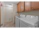 Functional laundry room with a sink, storage cabinets, and modern washer and dryer units at 220 Gregory Rd, Salisbury, NC 28147