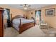 Bedroom with a four-poster bed, soft lighting, and floral window treatments at 220 Gregory Rd, Salisbury, NC 28147