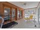 Enclosed sunroom featuring brick walls, tile flooring, and access to the backyard at 220 Gregory Rd, Salisbury, NC 28147