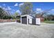 Spacious backyard features a garage, and large concrete area for extra parking at 2301 Shamrock Dr, Charlotte, NC 28205