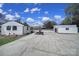 Spacious backyard features a carport, a garage, and large concrete area for extra parking at 2301 Shamrock Dr, Charlotte, NC 28205