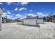 Spacious backyard features a carport, a garage, and large concrete area for extra parking at 2301 Shamrock Dr, Charlotte, NC 28205