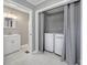 A clean bathroom features modern fixtures and vanity with a washing machine and dryer concealed by a curtain at 2301 Shamrock Dr, Charlotte, NC 28205