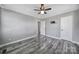 Spacious bedroom features neutral walls, hardwood flooring, and access to hallway at 2301 Shamrock Dr, Charlotte, NC 28205