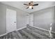 A well-lit bedroom features gray walls, modern ceiling fan, white trim and wood-look flooring at 2301 Shamrock Dr, Charlotte, NC 28205