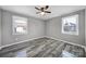 Unfurnished bedroom features hardwood floors, natural lighting, and neutral paint palette at 2301 Shamrock Dr, Charlotte, NC 28205