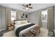 Staged bedroom includes a cozy bed, side tables, lamps, and decorative art at 2301 Shamrock Dr, Charlotte, NC 28205