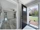 Inviting front entrance with a sleek black door, stylish hardware, and a well-lit foyer at 2301 Shamrock Dr, Charlotte, NC 28205