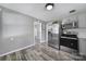 Open kitchen features stainless steel appliances, gray cabinets, and modern fixtures at 2301 Shamrock Dr, Charlotte, NC 28205
