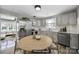 Staged kitchen featuring modern stainless appliances, gray cabinets, and hardwood floors at 2301 Shamrock Dr, Charlotte, NC 28205