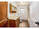 Bathroom featuring vanity, toilet, shower with wood door and vinyl floor at 260 Penninger Dr, Woodleaf, NC 27054