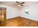 Bright bedroom with hardwood floors, neutral walls, and natural light streaming through the window at 260 Penninger Dr, Woodleaf, NC 27054