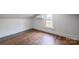 Bedroom featuring light walls, wood floor, and a window that provides ample light at 260 Penninger Dr, Woodleaf, NC 27054