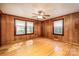 Bedroom featuring wood paneling, hardwood floors, and natural light from windows at 260 Penninger Dr, Woodleaf, NC 27054