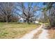 Quaint home featuring a sprawling front yard and rustic charm, complete with a long private drive at 260 Penninger Dr, Woodleaf, NC 27054
