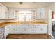 Charming kitchen featuring white cabinets, butcher block counters, and open shelving at 260 Penninger Dr, Woodleaf, NC 27054