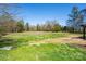 A picturesque large grassy area and some woods that enhance the beauty of the property at 260 Penninger Dr, Woodleaf, NC 27054