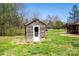 Quaint outbuilding with a wooden exterior, adding rustic charm to the property at 260 Penninger Dr, Woodleaf, NC 27054
