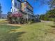Spacious backyard featuring a large deck, pergola, manicured lawn and mature trees at 2709 Yadkin Ave, Charlotte, NC 28205