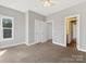 Carpeted bedroom with a window and double doors to a closet at 2709 Yadkin Ave, Charlotte, NC 28205