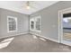 Spacious bedroom features a ceiling fan, large windows with ample natural light, and a door to backyard at 2709 Yadkin Ave, Charlotte, NC 28205