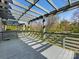 Spacious gray deck with pergola and railing offers an ideal outdoor entertaining and relaxation space at 2709 Yadkin Ave, Charlotte, NC 28205
