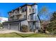 Three-story home with a three-car garage, private balconies and a blue entry door at 2709 Yadkin Ave, Charlotte, NC 28205