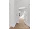 Bright hallway provides entry to another room with carpet floors, white walls, and natural light at 2709 Yadkin Ave, Charlotte, NC 28205