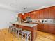 Stylish kitchen island with seating, wood cabinets, and stainless steel appliances at 2709 Yadkin Ave, Charlotte, NC 28205