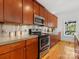Modern kitchen with stainless steel appliances, wooden cabinets, and concrete countertops at 2709 Yadkin Ave, Charlotte, NC 28205