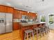 Spacious kitchen featuring wood cabinets, stainless steel appliances, and a large island with seating at 2709 Yadkin Ave, Charlotte, NC 28205