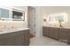 Bright bathroom features dual vanities, illuminated mirrors, and neutral tile flooring at 3119 Knowlton Ln, Charlotte, NC 28205