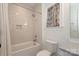 Bright bathroom with white subway tile surround, and a bathtub with shower at 3119 Knowlton Ln, Charlotte, NC 28205