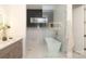 Modern bathroom features a glass-enclosed shower, soaking tub and vanity with gray cabinets at 3119 Knowlton Ln, Charlotte, NC 28205