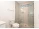 Modern bathroom with a glass-enclosed shower and built in bench and white tile at 3119 Knowlton Ln, Charlotte, NC 28205