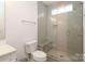 Bathroom showcasing a glass enclosed shower with a bench and tiled walls at 3119 Knowlton Ln, Charlotte, NC 28205